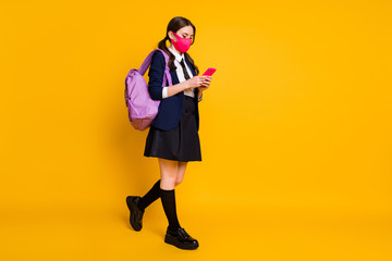 Full length body size view of her she nice attractive brown-haired focused schoolgirl using device chatting 5g app blogging isolated on bright vivid shine vibrant yellow color background