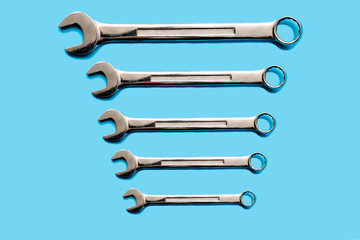 wrenches from large to small on a blue background.concept of working tools.