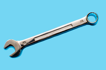 wrench on a blue background top view. Service concept.