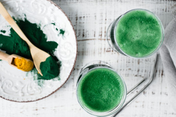 Healthy green vegan smoothie with spirulina and turmeric for detoxification. Spirulina smoothie.