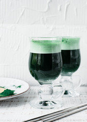 Healthy green vegan smoothie with spirulina and turmeric for detoxification. Spirulina smoothie.