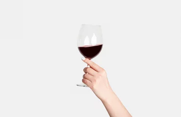 Rolgordijnen Young girl holding glass of tasty red wine on white background, closeup © Prostock-studio
