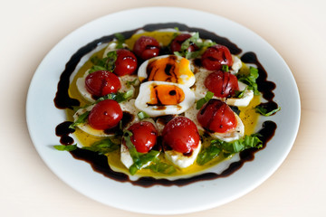 mozzarella - tomatoes in olive oil and balsamic vinegar and basil and cooked egg