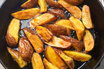 Fried crispy potatoes in oil in a pan. Cooking potatoes in a rustic way.