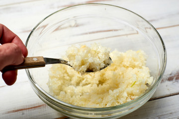 Finely chopped onions on a light wooden background.