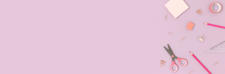 Top view of various stationery on a purple pastel background. Back to school concept banner with place for text.