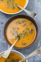 vegetable soup with spinach on ceramic background