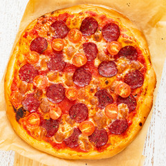 pizza with salami and cherry tomatoes