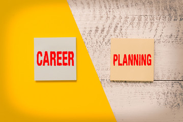 Text sign showing Career Planning. Business photo showcasing Strategically plan your career goals and work success Two multicolor blank notepads colored paper sheet retro wooden background