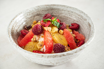 granola with banana and raspberries