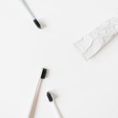 Toothbrushes, toothpaste on white background. Flat lay, top view oral care, dental hygiene concept.