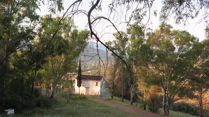 Fototapeta na wymiar Small house on hillside with good view