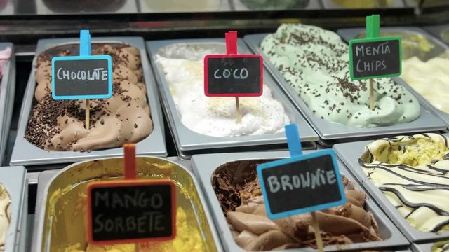 Tasty vegan Ice Cream Brownie Mango strawberries coco chocolate menta Flavor homemade at shop display cabinet in Italy Close-up