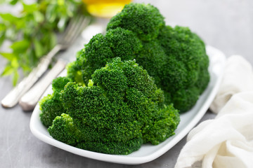 boiled broccoli on white dish on ceramic background