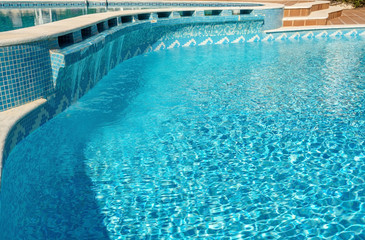 Traditional design swimming pool for tourists at the hotel. Against the backdrop of the bright sun.