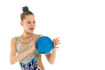 little girl is engaged in fitness with a ball.