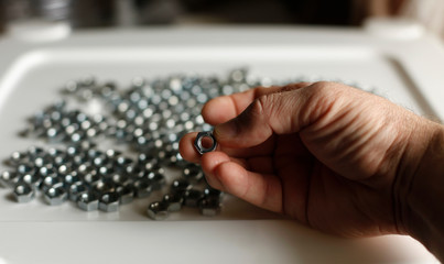 
Close-up of a man holding a nut with his fingers