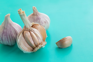 three heads of garlic on a blue background