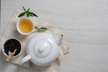 Organic tea on the white stone background.