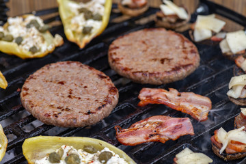 grilled vegetables and meat for burgers on a garden grill