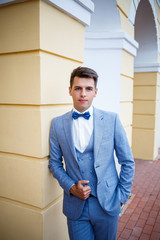 young guy businessman groom on their wedding day, stylish clothing, a walk in the park