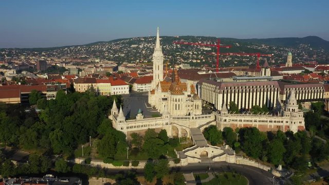 Drone flies slowly right at the Fisherman's Bastion and Matthias Church in the early morning at spring time and clear weather high altitude. Budapest, Hungary