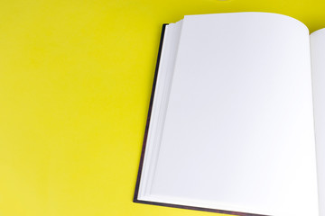 Empty book booklet mockup with blank pages and copy space on yellow background. Top view. Template for magazine, portfolio and catalogue