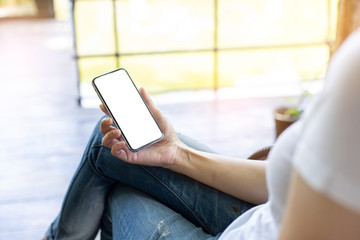 cell phone Mockup image blank white screen.woman hand holding texting using mobile on desk at coffee shop.background empty space for advertise.work people contact marketing business,technology