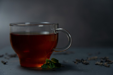 tea with mint and lemon on a dark background