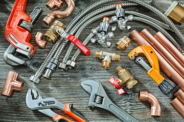 plumbing concept big set of piping accessories monkey and plumb adjustable wrenches copper brass...