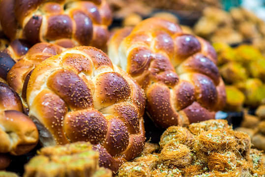 Fresh traditional Challah bread and Kadaif sweets - beautiful Israeli and Middle Eastern food in "The Shuk" - Mahane Yehuda Market , Jerusalem Israel