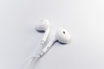 close up of an earphone with white background.