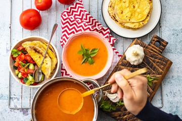 Orange pumpkin carrot creamy vegetables soup in bowl with rucola herb on top. Vegan food lunch