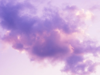 Purple puffy and fluffy clouds in the sunset sky.