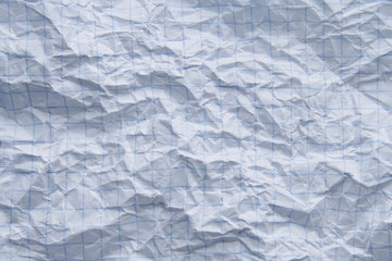Crumpled white checkered paper sheet full frame use as background for text

