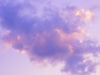 Purple puffy and fluffy clouds in the sunset sky.