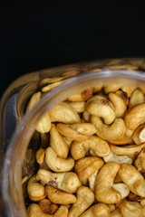 close up of cashew nuts with black background.