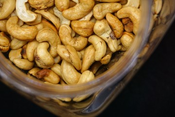 close up of cashew nuts with black background.