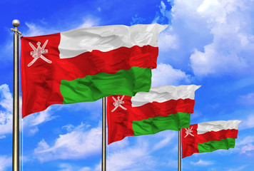 Oman National Flags Waving In The Wind On A Beautiful Summer Blue Sky