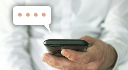 Online chat chatting on application communication digital media website and social network. Hand of man typing text on mobile smartphone.