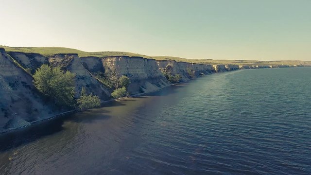 Flying over water along a cliff