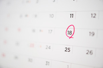 Red circle mark at 18th on calendar date business planning appointment meeting concept