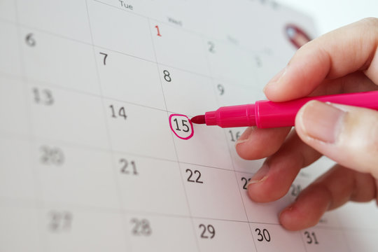 Hand With Pen Mark At 15th On Calendar Date