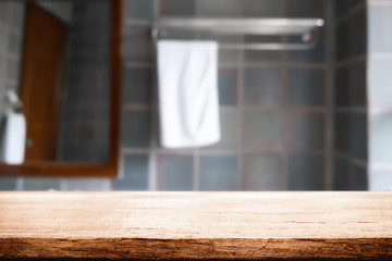 Wood desk free space over bathroom background for product display. Business presentation
