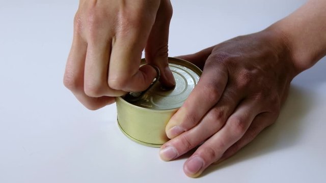 Close up female hand open preserved fish caviar. Canned food stock. Corona virus crisis. Hunger concept. Opening jars with caviar. Healthy Food, Healthy Nutrition Without GMOs, Without Glut