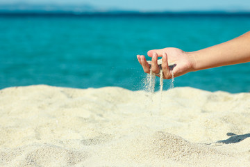 female hand pours sand