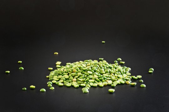 Green lentils isolated as a simple ingredient on black background