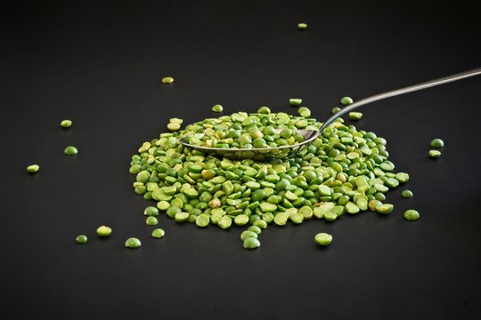 Green lentils isolated as a simple ingredient on black background