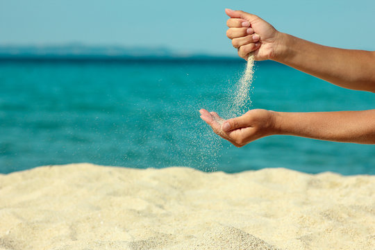 female hand pours sand