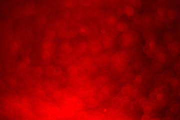 Red glitter vintage lights background. Red bokeh on black background.